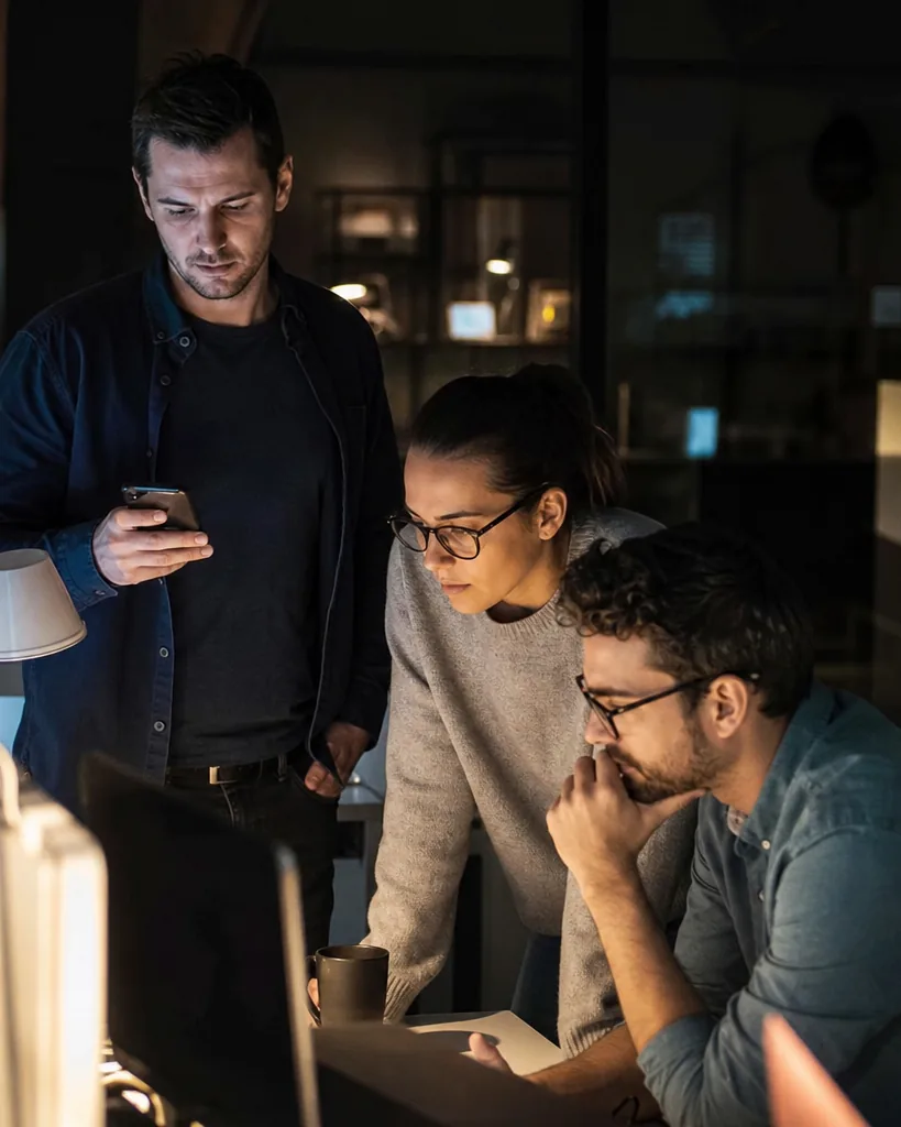 On-call engineers at night reacting to a phone alert